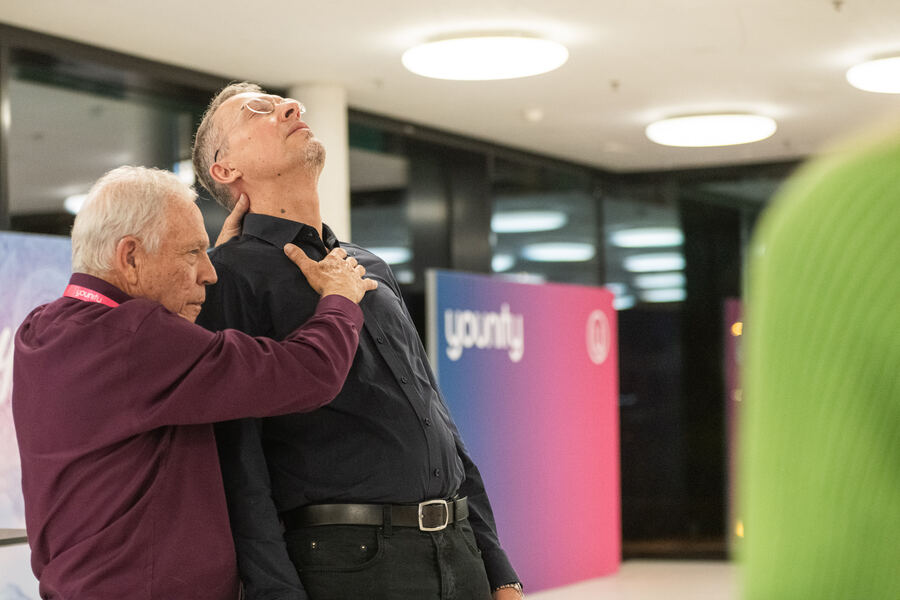 Dr. Frank Kinslow supporting a man with QE touch