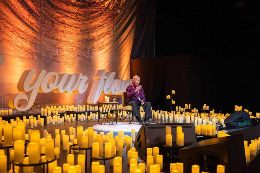 Dr. Frank Kinslow sitting on stage during a seminar