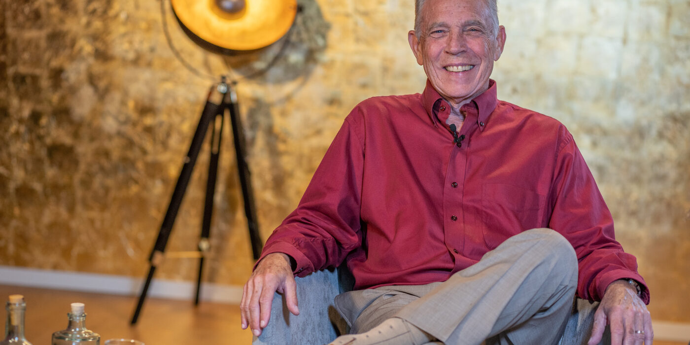 Dr. Frank Kinslow seated, looking relaxed and contemplative